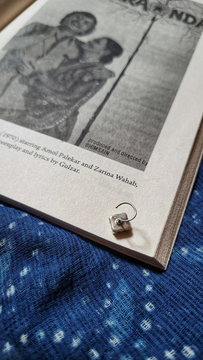 Side view of Patang Nose-Pin in pure silver with handcrafted detailing