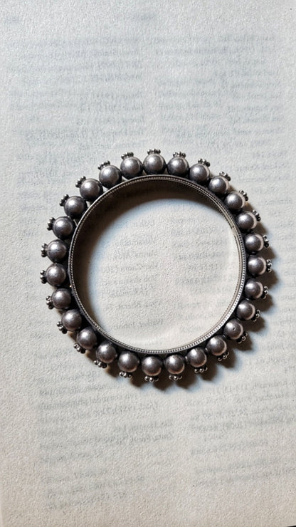 Side view of Priyadarsini Kada in pure silver with handcrafted detailing