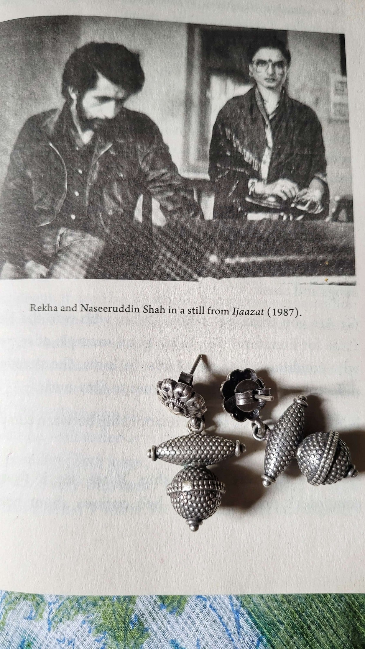 Two actors in a still from the movie 'Ijaazat' with a close-up of Riddhita Earrings  below.