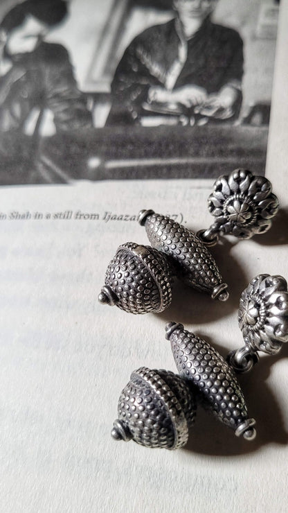 Side view of Riddhita Earrings in pure silver with handcrafted detailing