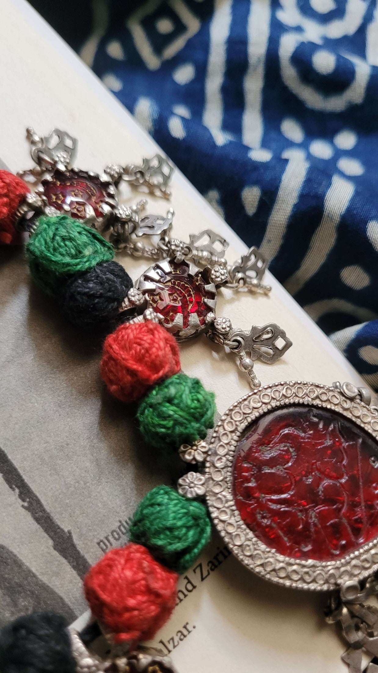 Saaki Vintage Necklace with colorful beads and intricate design on a textured surface