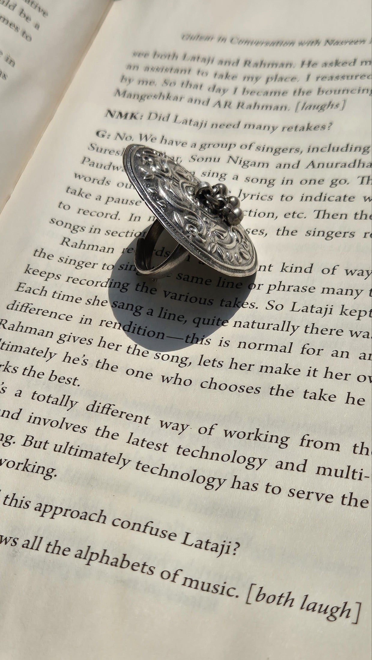 Decorative ring on an open book with text