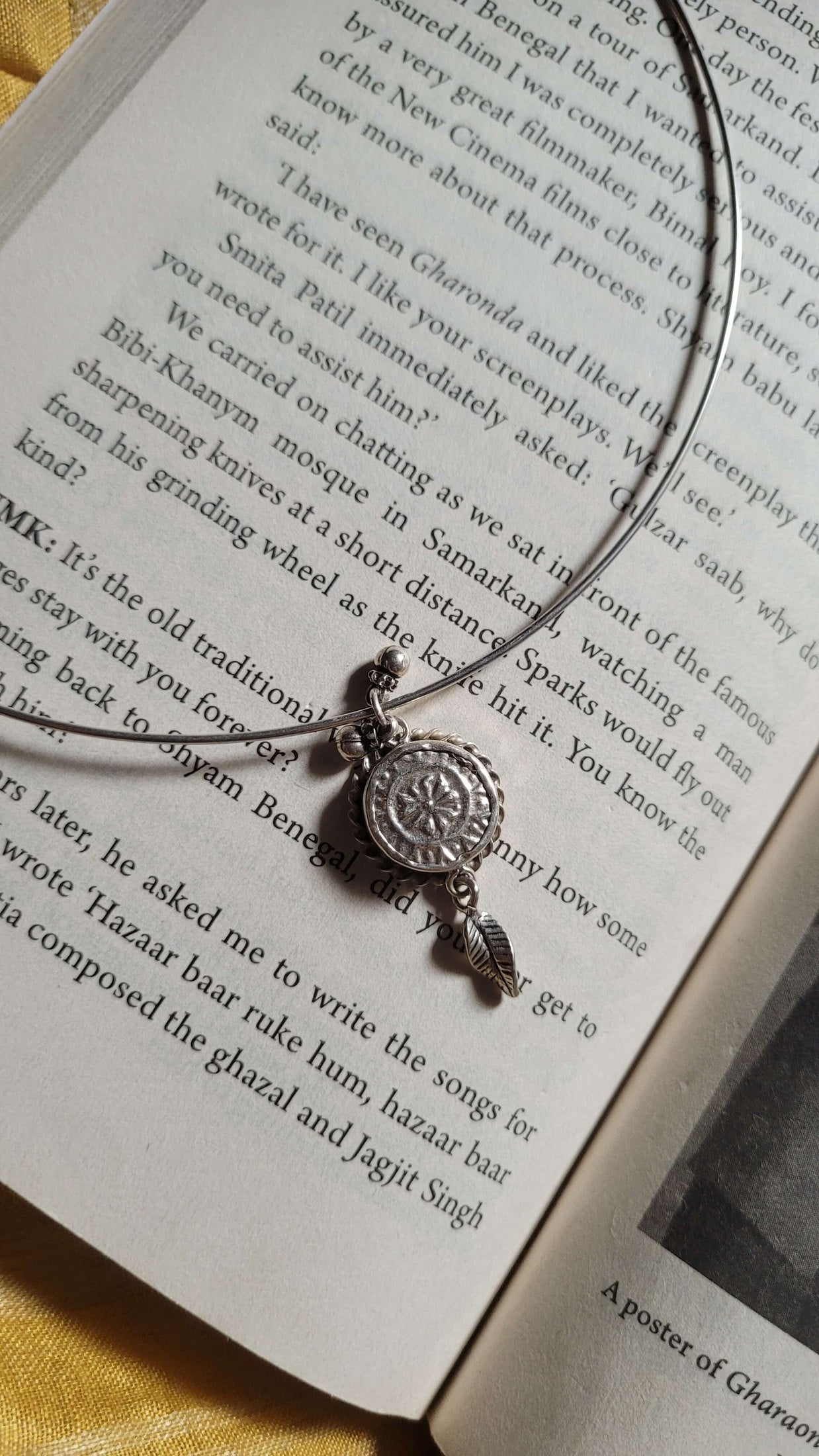 Necklace with a pendant on an open book