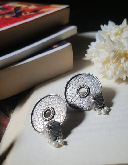 Side view of Vasu Earrings in pure silver with handcrafted detailing