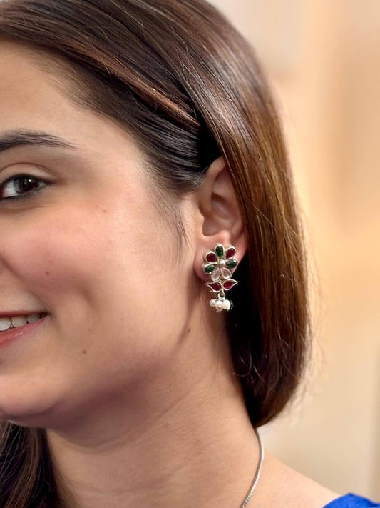 Close-up of a woman wearing a floral earring with a blurred background
