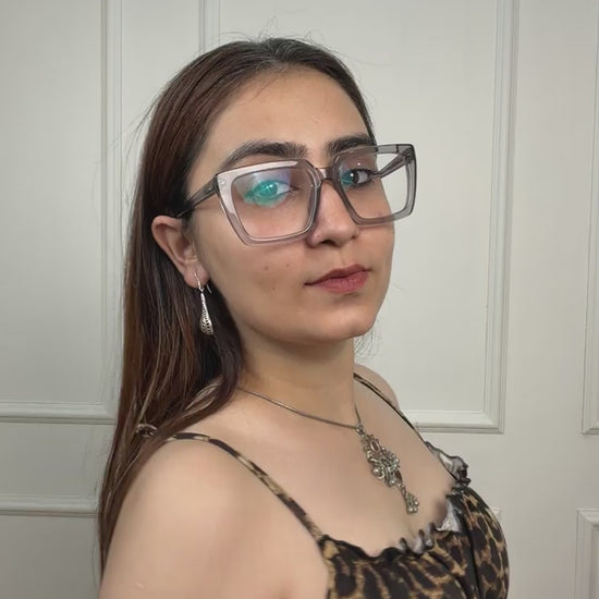 Video of a rare vintage silver maximalist pendant — hand-cut glass sunflower with red centre and yellow petals, maroon glass heart dangler, turquoise accent, dense ghungroos and geometric danglers throughout. Available with or without chain. Shop Sadabahaar Jewelry.